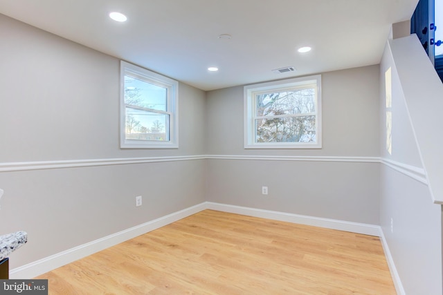 spare room featuring wood-type flooring