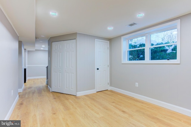 interior space with light hardwood / wood-style flooring and two closets