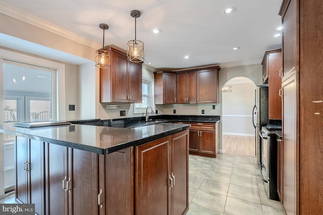 kitchen featuring crown molding, appliances with stainless steel finishes, light tile patterned floors, sink, and decorative light fixtures