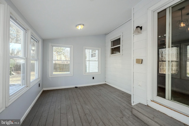 unfurnished sunroom with lofted ceiling