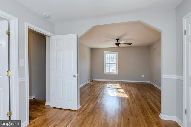 unfurnished bedroom featuring hardwood / wood-style flooring and ceiling fan