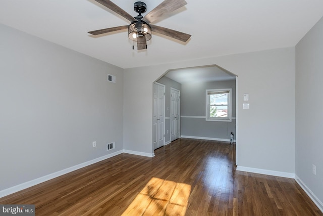 interior space with ceiling fan and dark hardwood / wood-style flooring