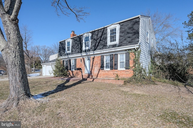 view of front of house featuring a garage and a front lawn