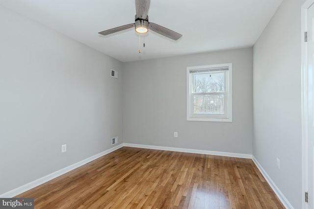 empty room with light wood-type flooring and ceiling fan