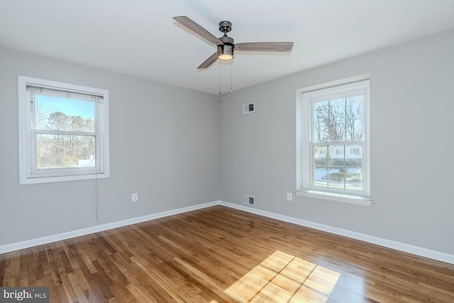 unfurnished room with hardwood / wood-style flooring and ceiling fan