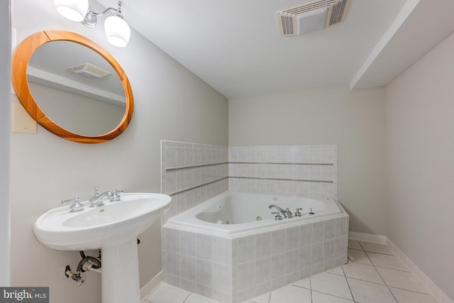 bathroom with tiled bath and tile patterned flooring