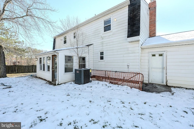 snow covered property featuring cooling unit