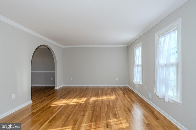 spare room featuring crown molding and wood-type flooring