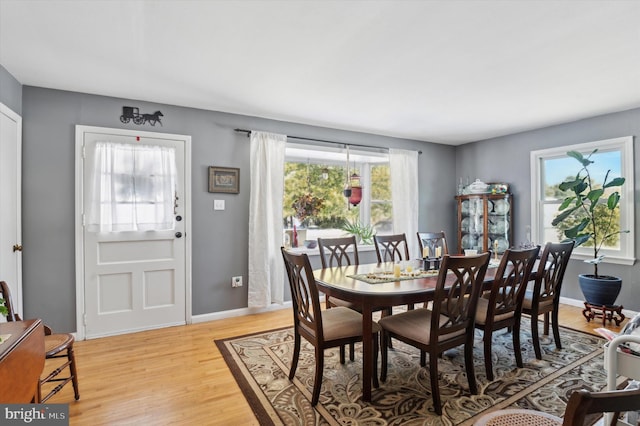 dining space with light hardwood / wood-style flooring