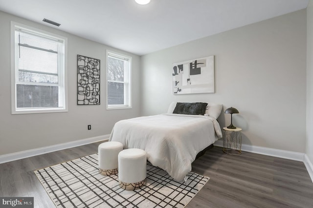 bedroom with dark hardwood / wood-style floors