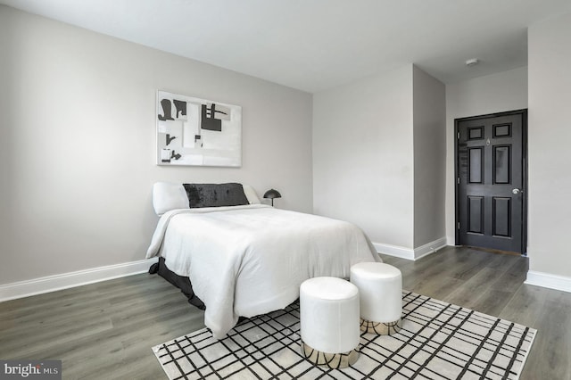 bedroom with dark hardwood / wood-style flooring