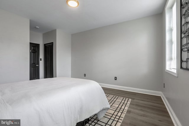 bedroom featuring dark hardwood / wood-style floors and a closet