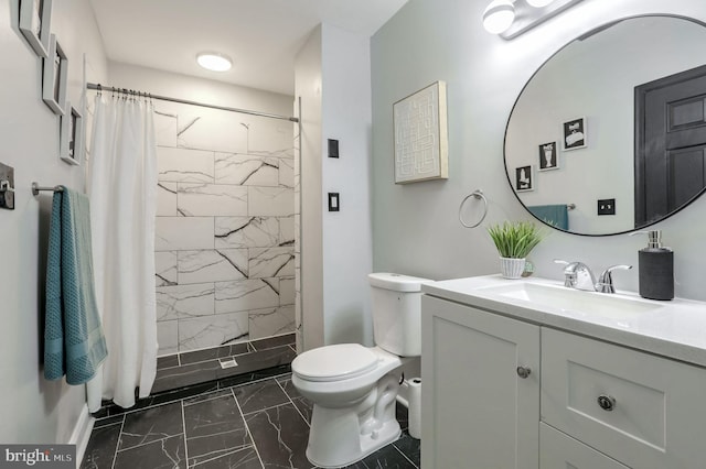 bathroom with vanity, curtained shower, and toilet