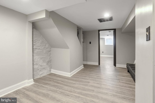 additional living space featuring light wood-type flooring