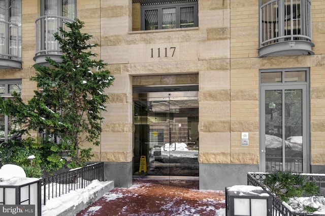 view of snow covered property entrance