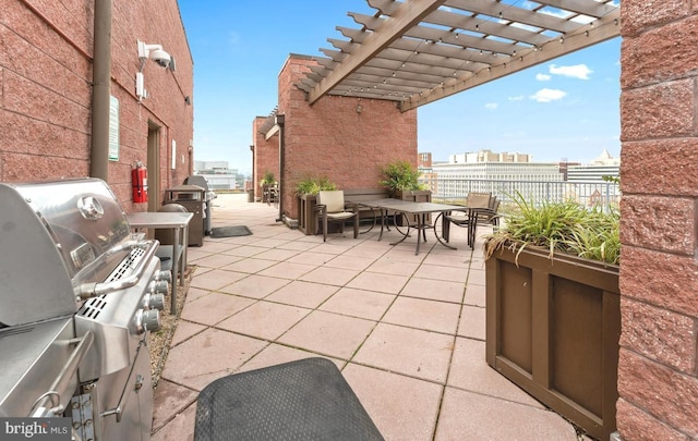 view of patio featuring a pergola, exterior kitchen, and a grill