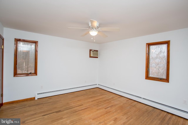 unfurnished room with baseboard heating, a wall mounted AC, ceiling fan, and light hardwood / wood-style floors