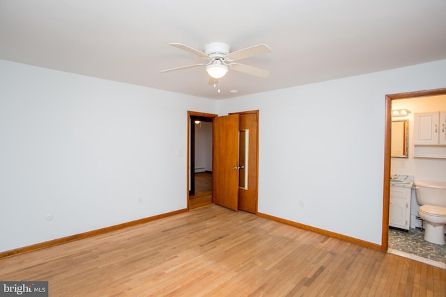 unfurnished bedroom with baseboard heating, ensuite bath, ceiling fan, and light hardwood / wood-style flooring