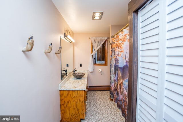 bathroom with tile patterned flooring, vanity, a baseboard radiator, and walk in shower