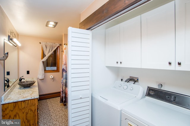 laundry area with washer and clothes dryer, sink, cabinets, and a baseboard heating unit