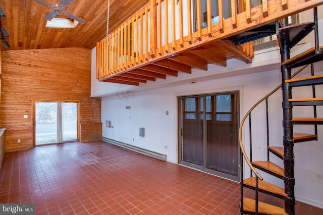 unfurnished living room featuring wood walls, high vaulted ceiling, dark tile patterned flooring, baseboard heating, and wood ceiling