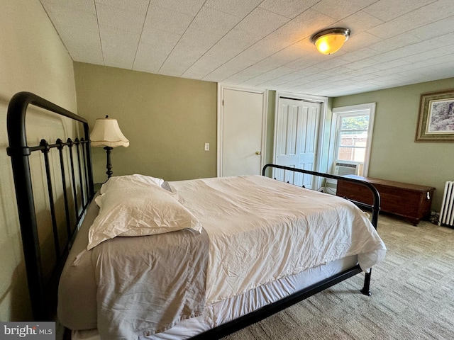 carpeted bedroom featuring radiator