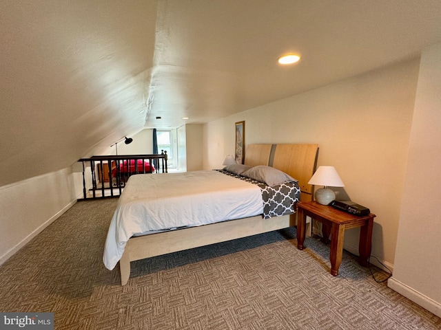 bedroom featuring carpet floors and vaulted ceiling