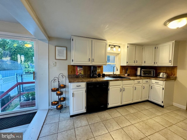 kitchen featuring backsplash, sink, white cabinetry, and black dishwasher