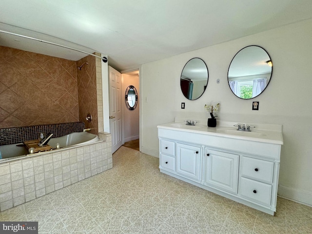 bathroom featuring vanity and tiled shower / bath