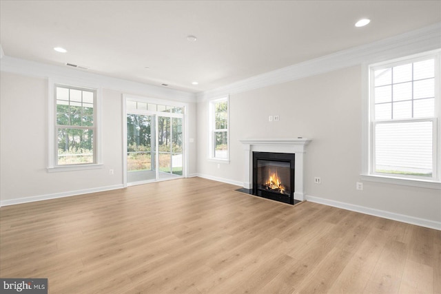 unfurnished living room featuring light hardwood / wood-style floors and ornamental molding