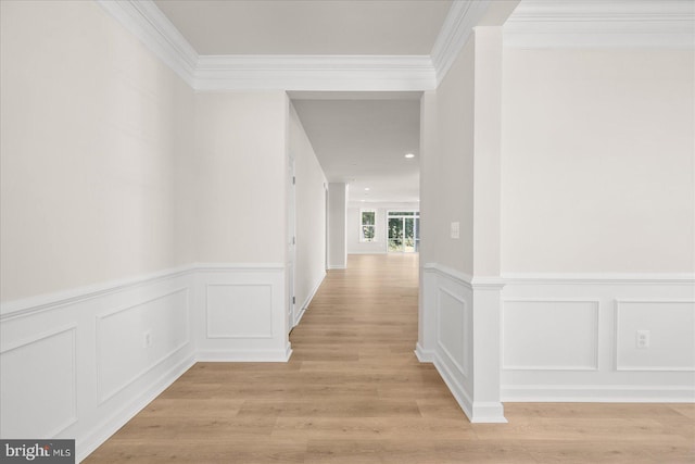 hallway featuring light hardwood / wood-style floors and crown molding