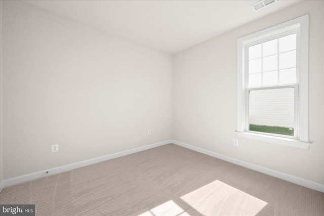 unfurnished room with light colored carpet