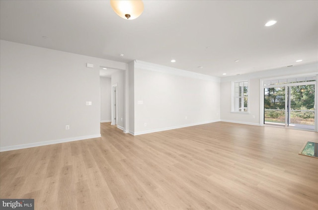 spare room with light hardwood / wood-style flooring and ornamental molding