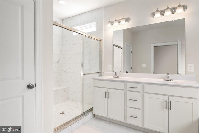 bathroom with vanity and a shower with shower door