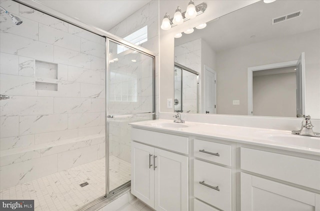 bathroom featuring vanity and a shower with door