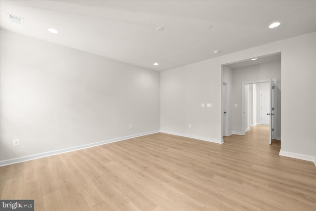 empty room with light hardwood / wood-style flooring