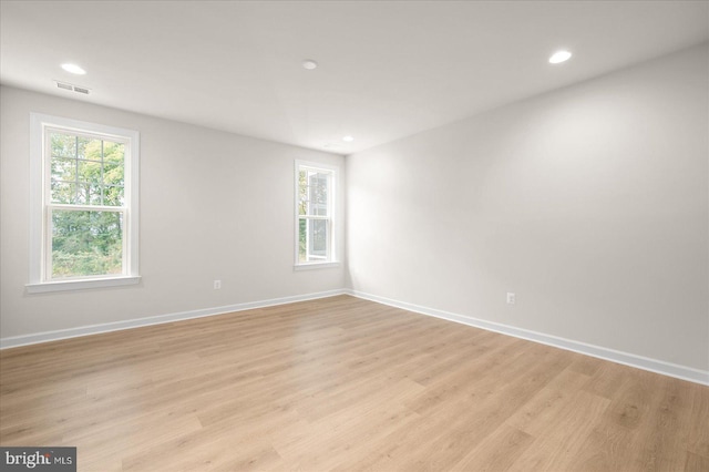 spare room featuring light hardwood / wood-style floors