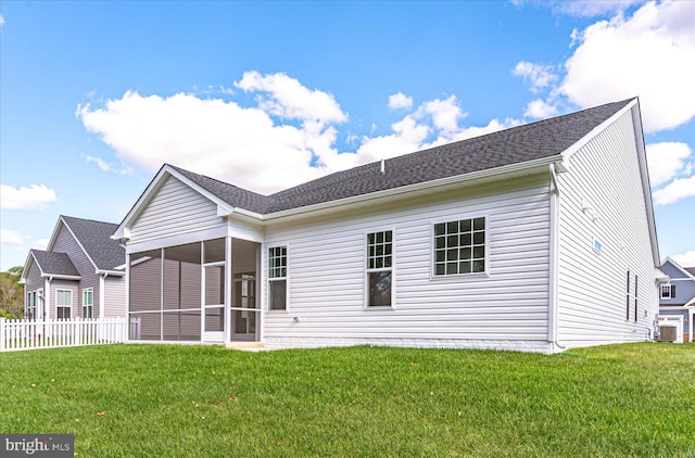 rear view of property featuring a yard, central AC, and a sunroom