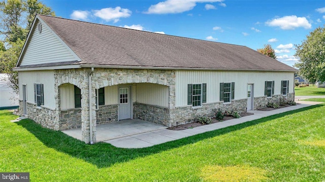 back of property with a lawn and a patio