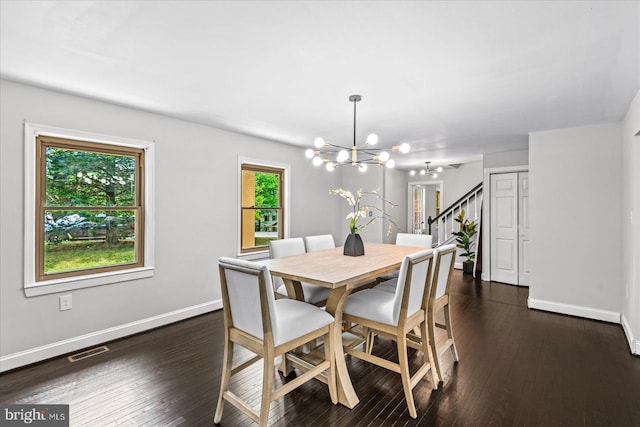 dining area with dark hardwood / wood-style floors and a chandelier