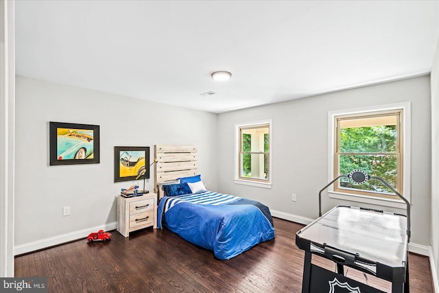 bedroom with dark hardwood / wood-style flooring