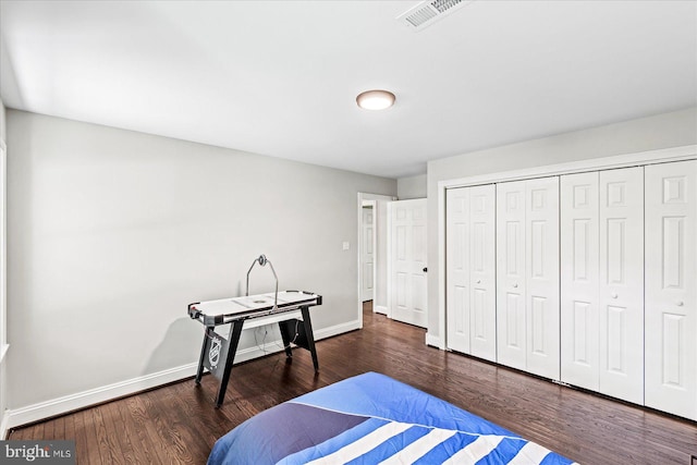 bedroom featuring dark hardwood / wood-style floors and a closet