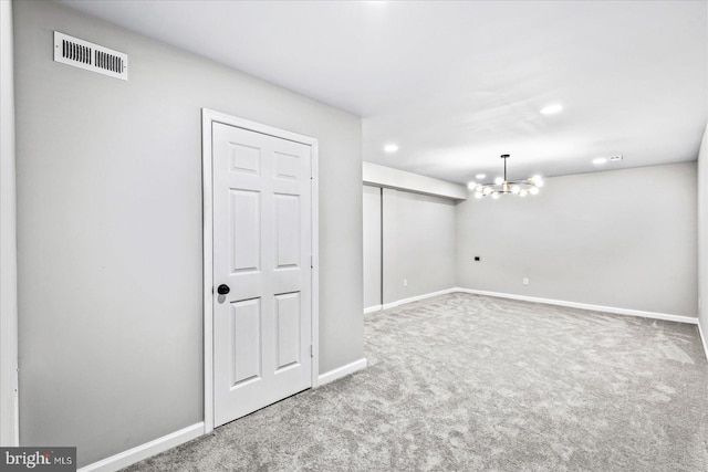 basement with carpet floors and an inviting chandelier