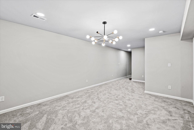 basement featuring carpet flooring and a notable chandelier