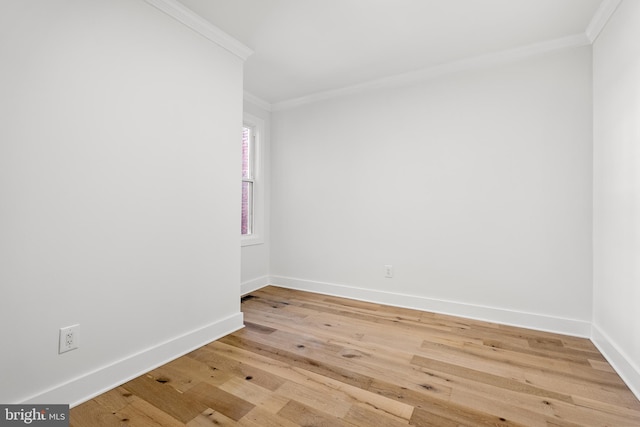 spare room featuring light hardwood / wood-style floors and ornamental molding