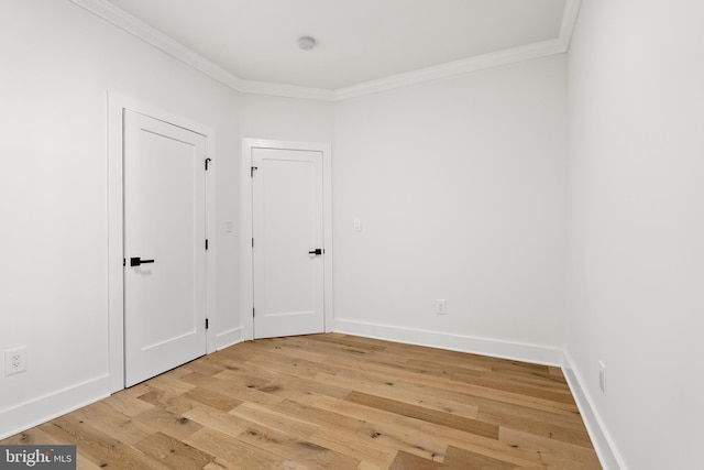 unfurnished room with wood-type flooring and ornamental molding