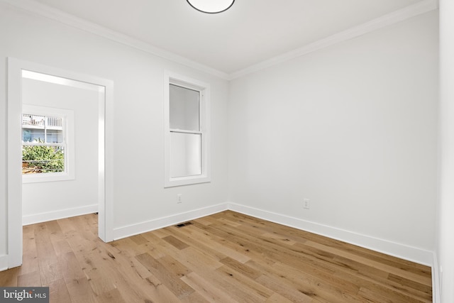 unfurnished room featuring light hardwood / wood-style floors and ornamental molding