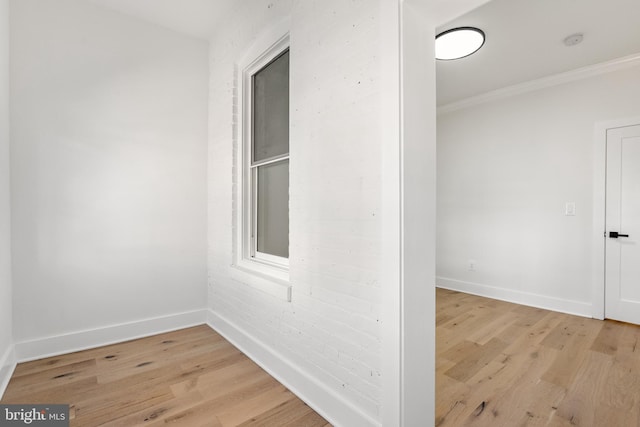 interior space with light wood-type flooring and crown molding