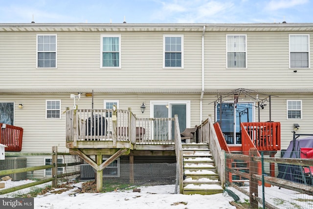 snow covered property featuring a deck and central air condition unit