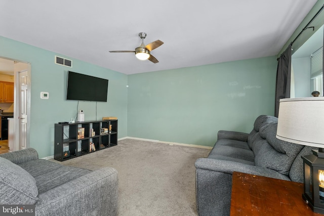 living room featuring dark carpet and ceiling fan